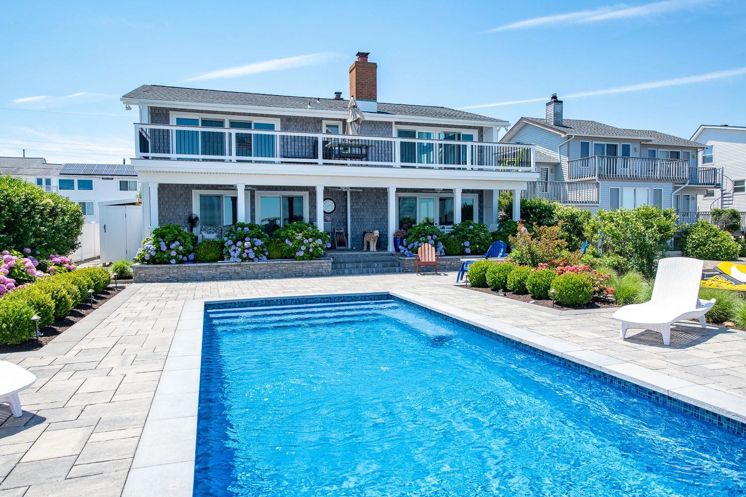 The finished home with pool and landscaped patio
